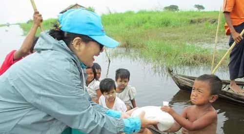 A boy is given food after the flood in Kale, Myanmar.