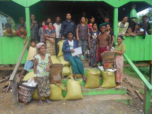 Flood victims are given rice in Nakzaang Village after the flood.