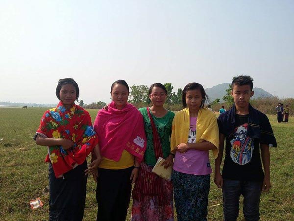 Four baptized believers stand together after water baptisms.