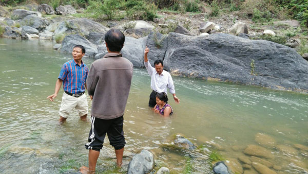 A new convert being baptized in Matupi