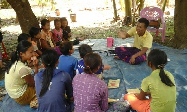 Brother Saw Regab sharing the gospel to a small group